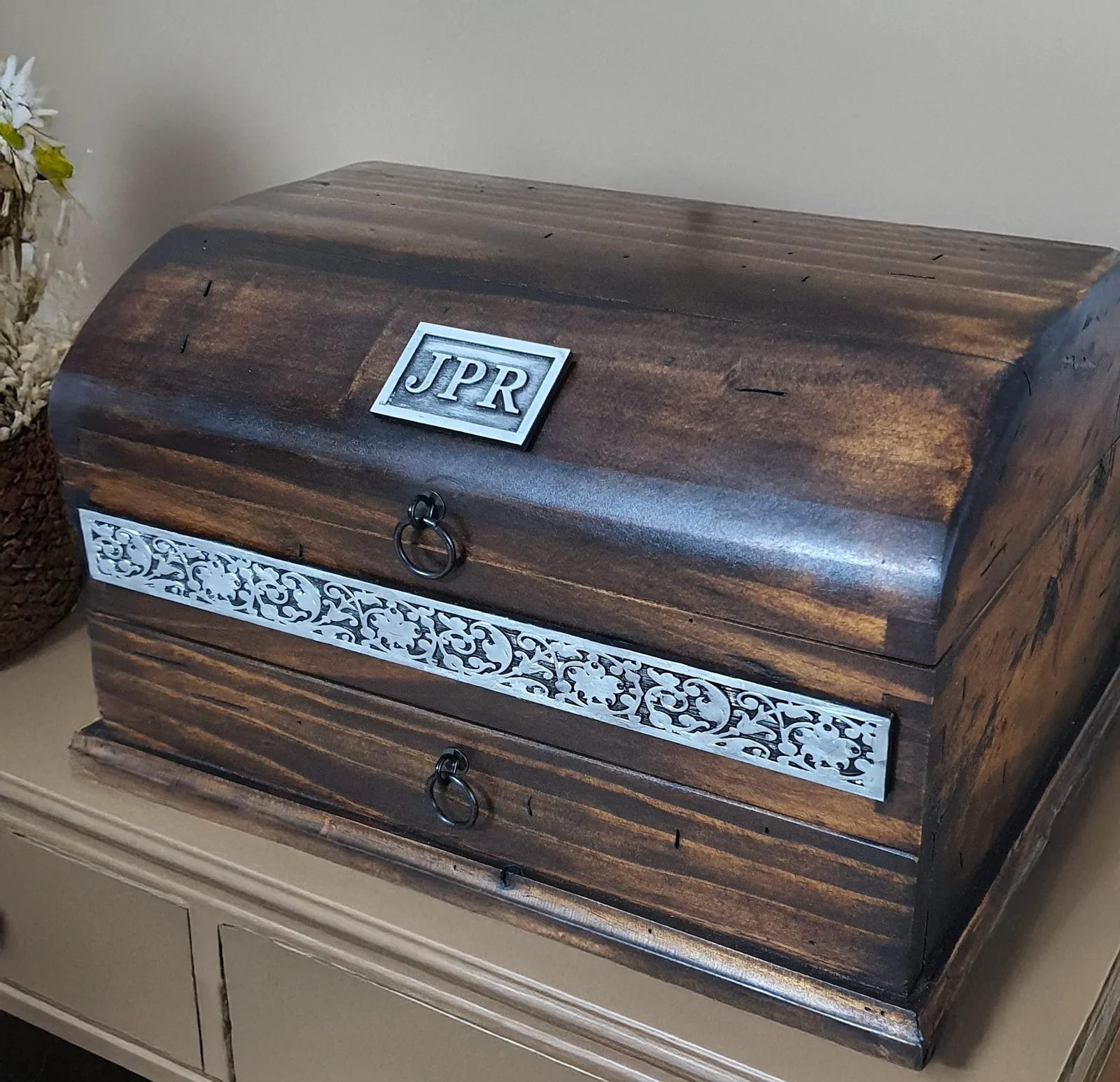 Customer photograph of a handcrafted domed Deferichs wooden box personalized with a JPR nameplate and decorative metal trim.