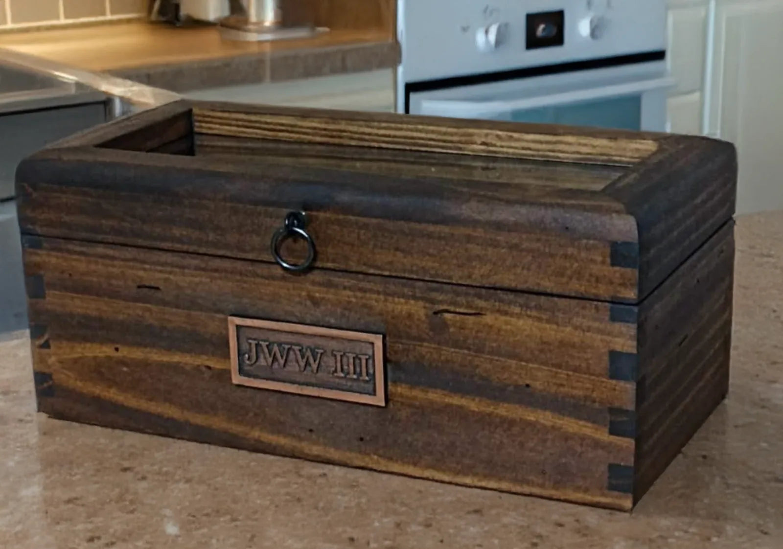 Customer photograph of a handcrafted glass-lid Deferichs box personalized with a JWW III nameplate.