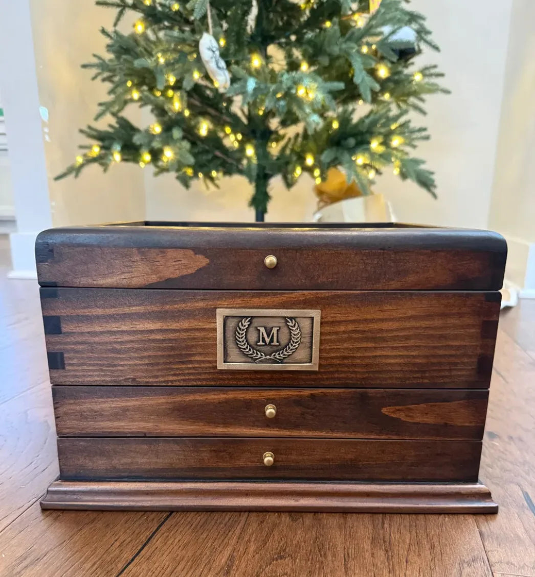 The same personalized watch box closed, showing its handcrafted wood grain and brass plate.