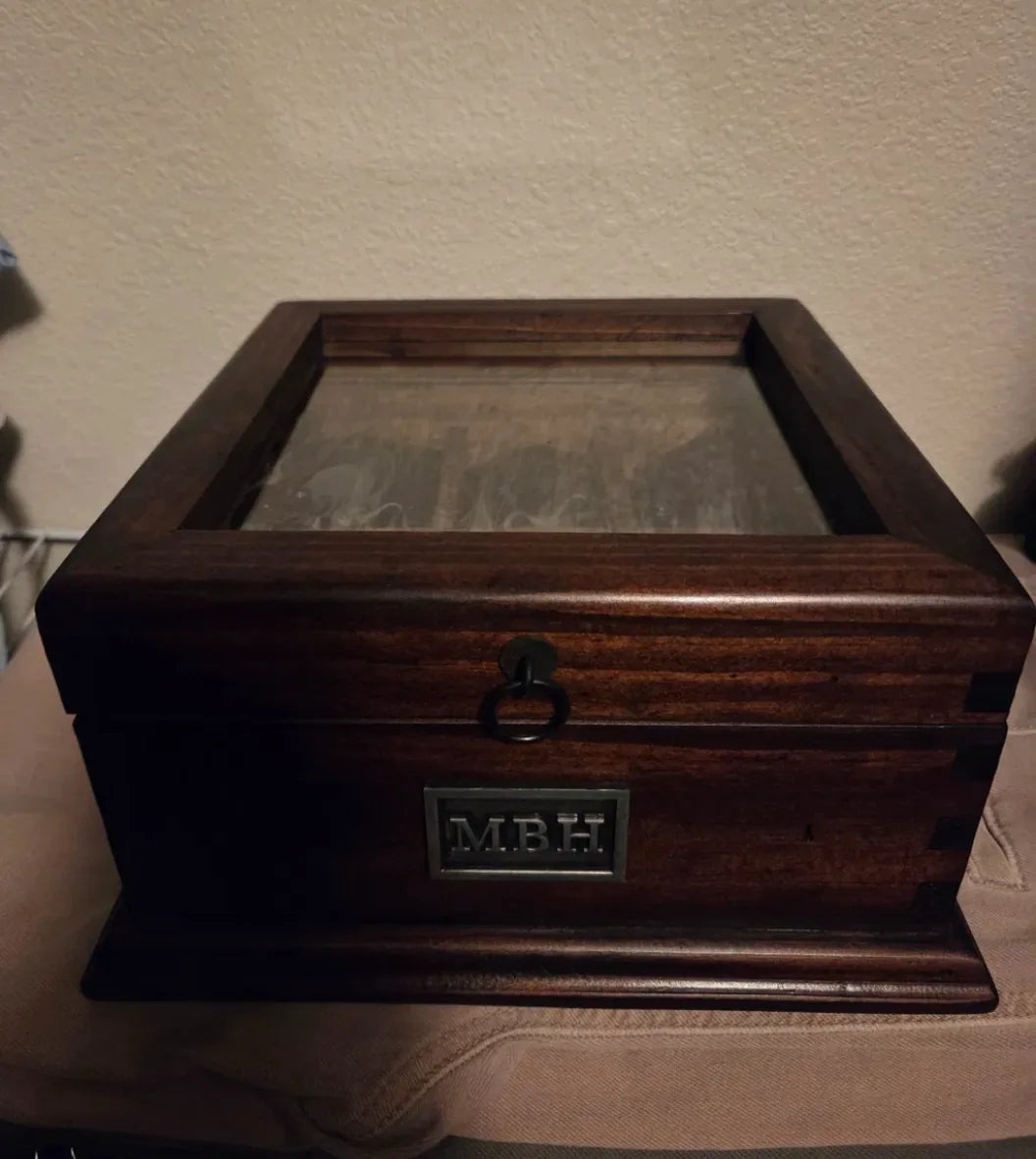 A personalized Deferichs watch box with the initials MBH on a customer’s dresser.