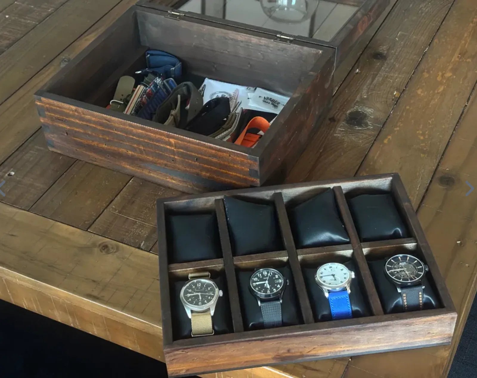 A rustic wooden watch box with its removable watch tray displayed beside it.