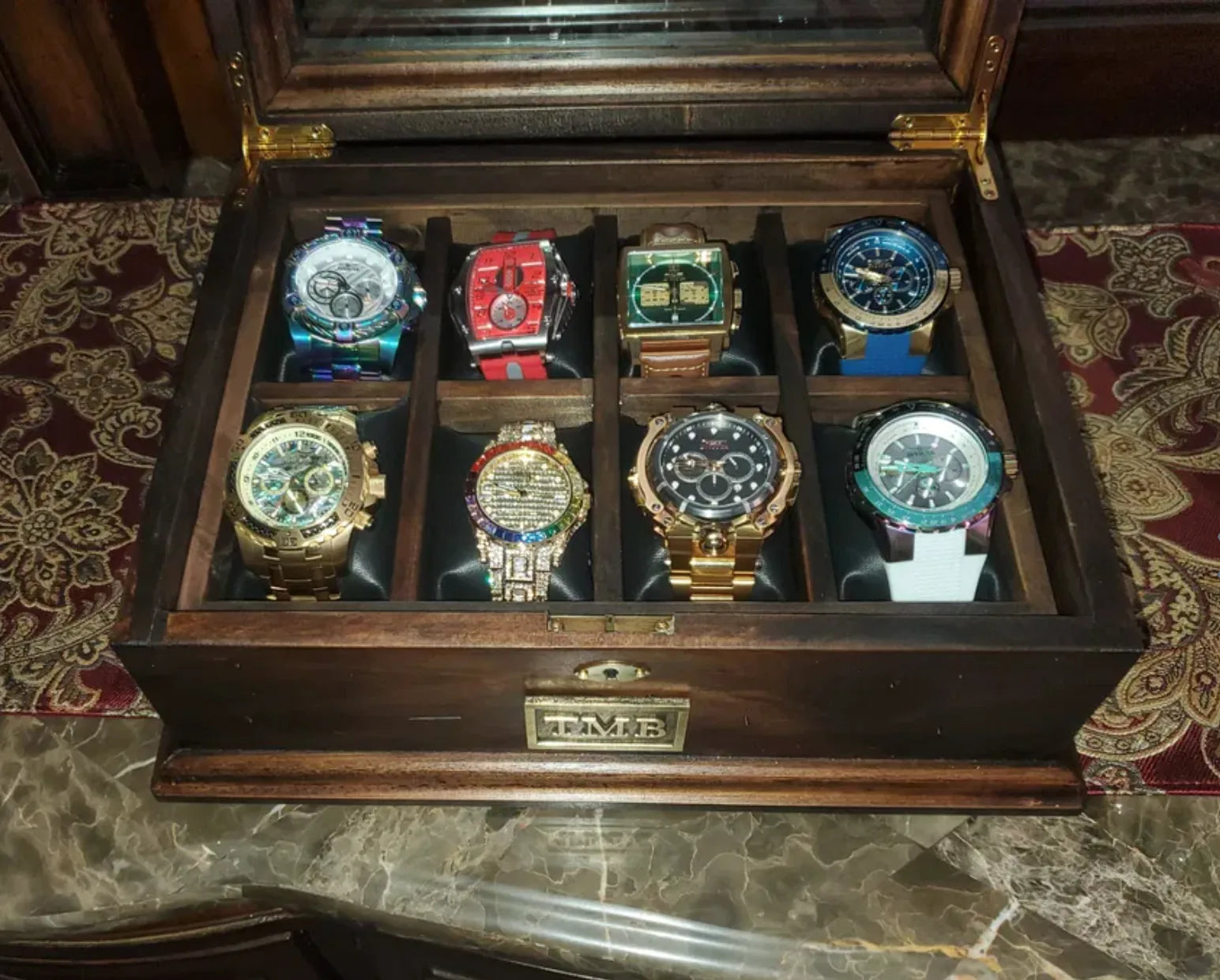 Eight watches displayed inside a personalized Deferichs watch box.