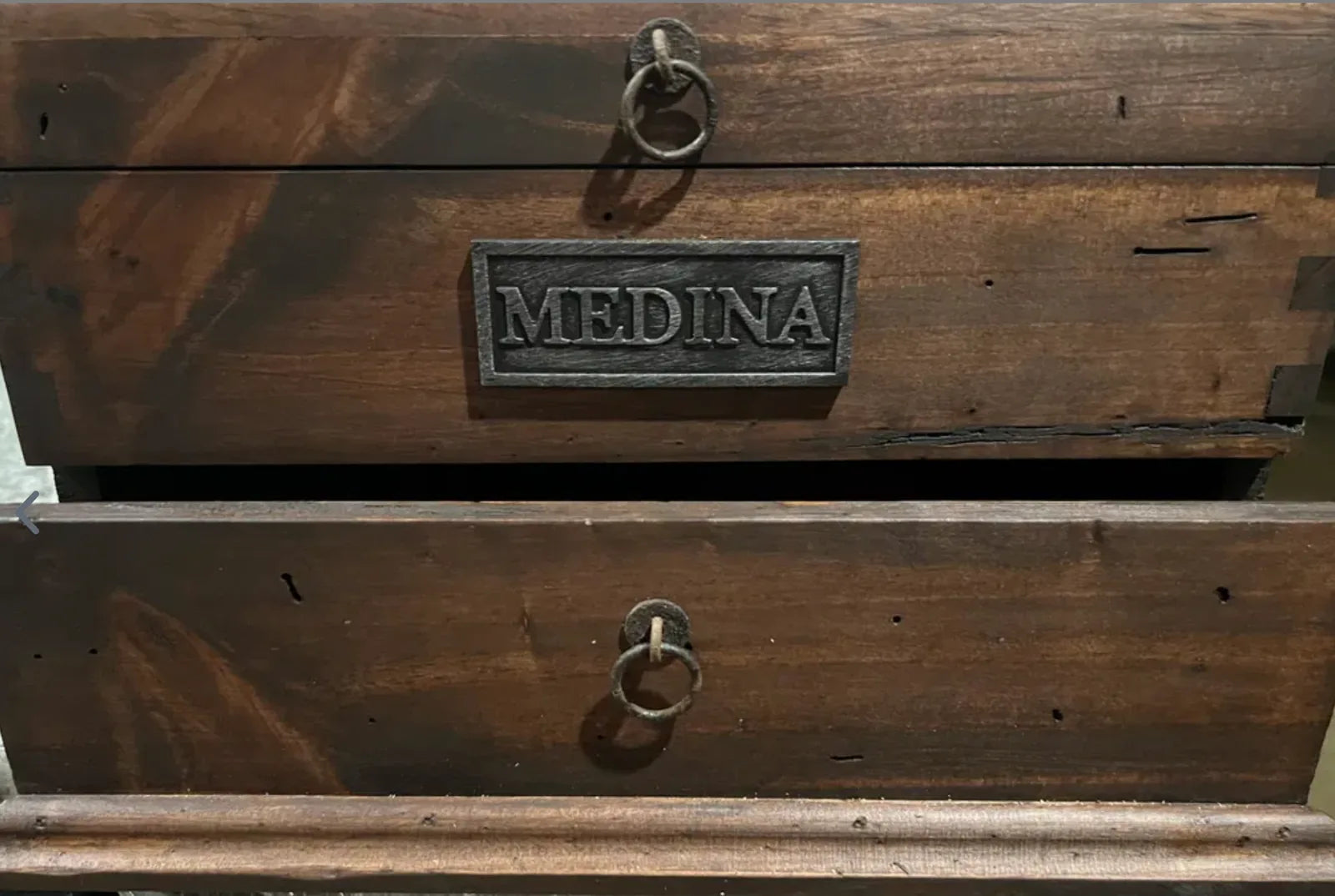 Close-up of a MEDINA personalized plate and ring pulls on reclaimed wood drawers.